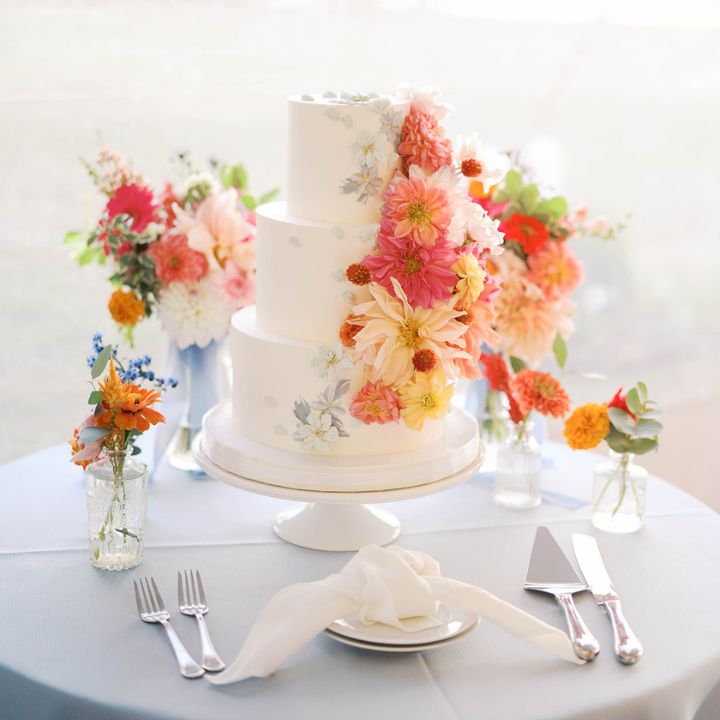 cake sq White three tier cake with pink, peach, coral, orange dahlias and zinnas