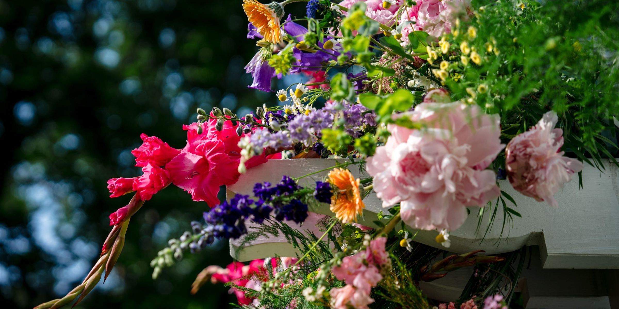 Closeup of colorful bright spring flowers on a wedding ceremony arch.