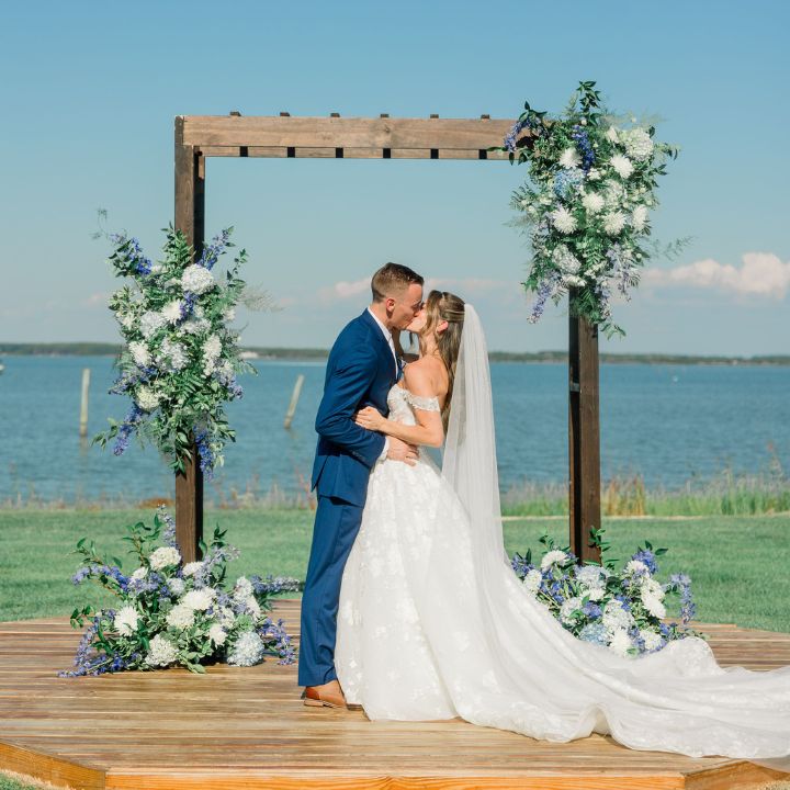 Wooden wedding ceremony arch with blue and white flowers at the Wylder Hotel