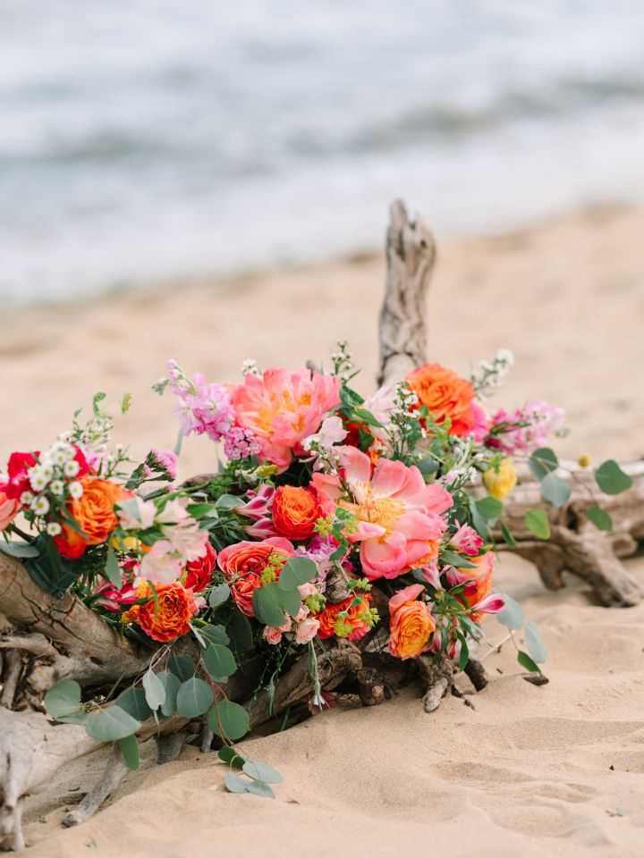 Detail of coral flowers on a beach wedding.