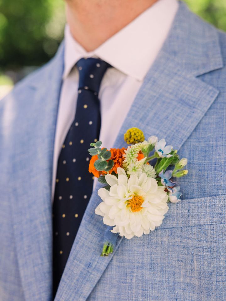 dahlia boutonniere Light blue suit with flower boutonniere.