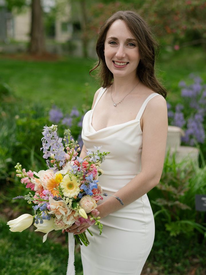 danni petite organic Bride holds a petite organic shaped bouquet in soft pastel spring colors.