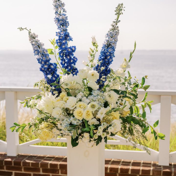 Blue and white floral pedestal arrangement.