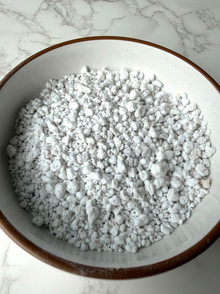 Closeup of white perlite pieces in a bowl.
