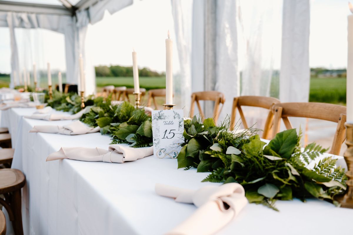 Greenery garland at wedding guest table.