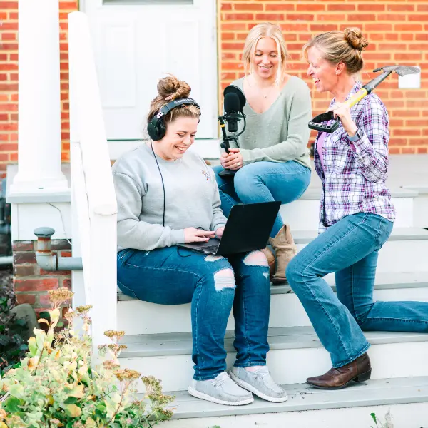 Amber, Lizzy, and Liza on the steps with podcast equipment for The Flower Files