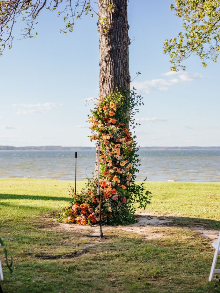 Fall florals installed on a tree at Queenstown Harbor Golf for a wedding ceremony.