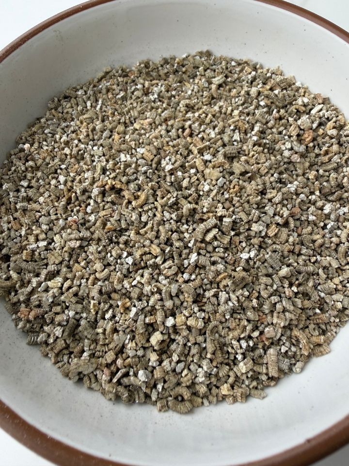 Closeup of vermiculite pieces in a small bowl.