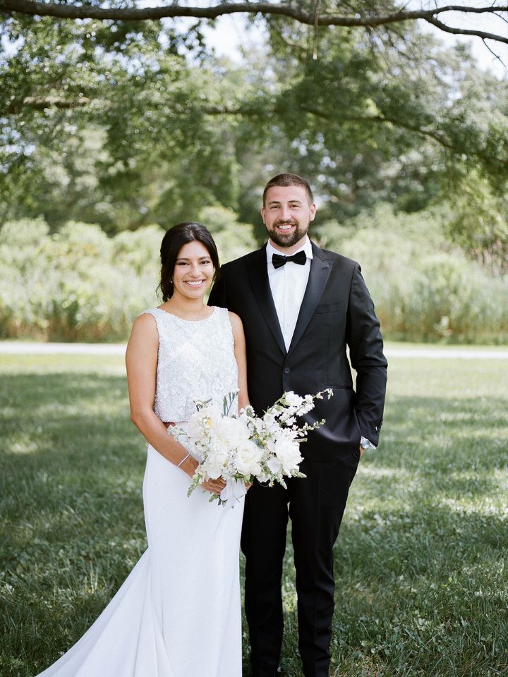 Bride and groom pose for wedding portrait.