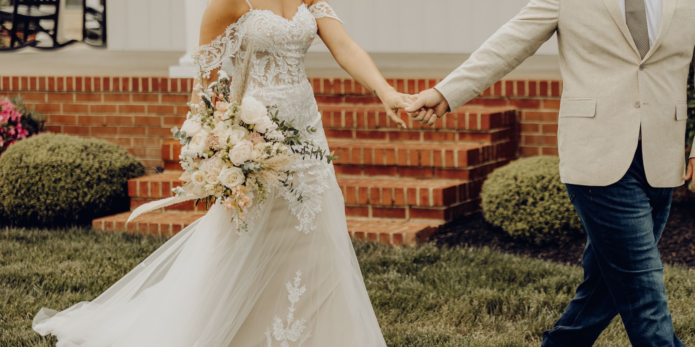Bride and groom walk and hold hands