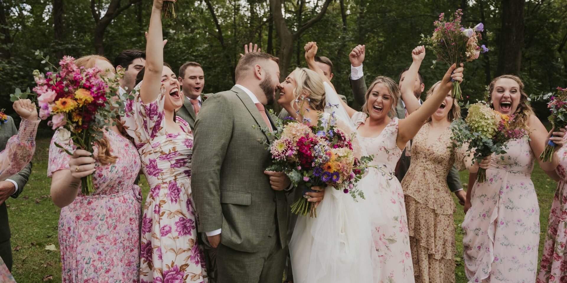 Bride and Groom kiss while wedding party cheers.