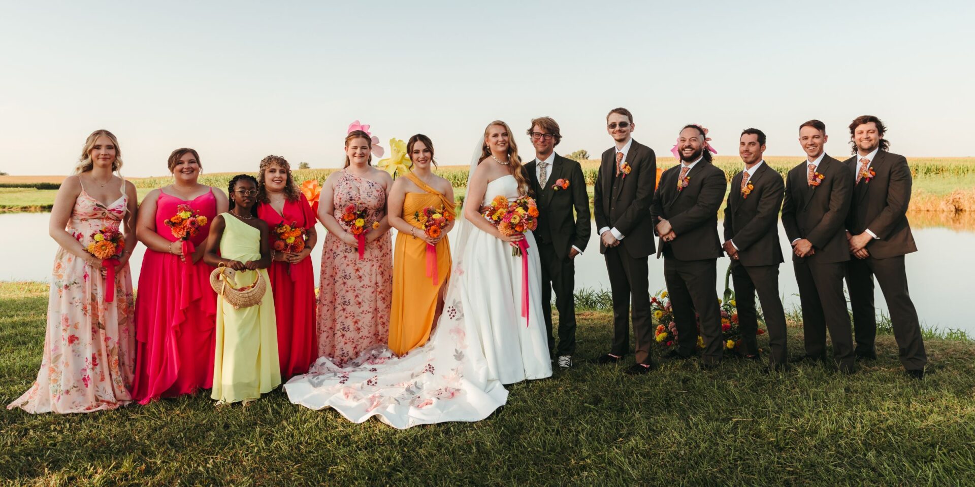 Bride and groom stand with wedding party.