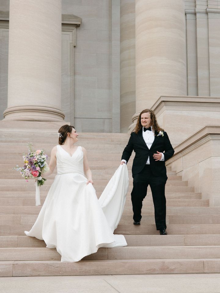 Bride and groom walk down steps in Washington, DC