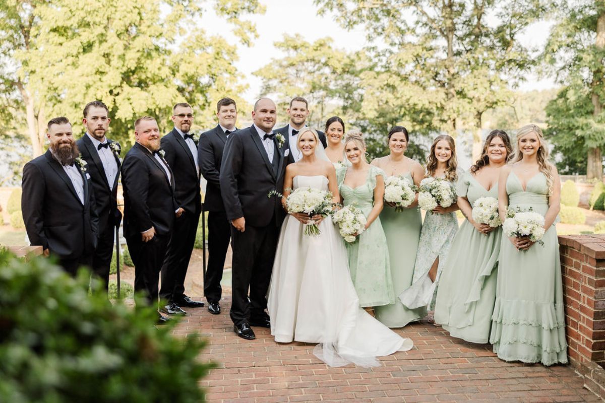 Wedding party lined up on either side of bride and groom.