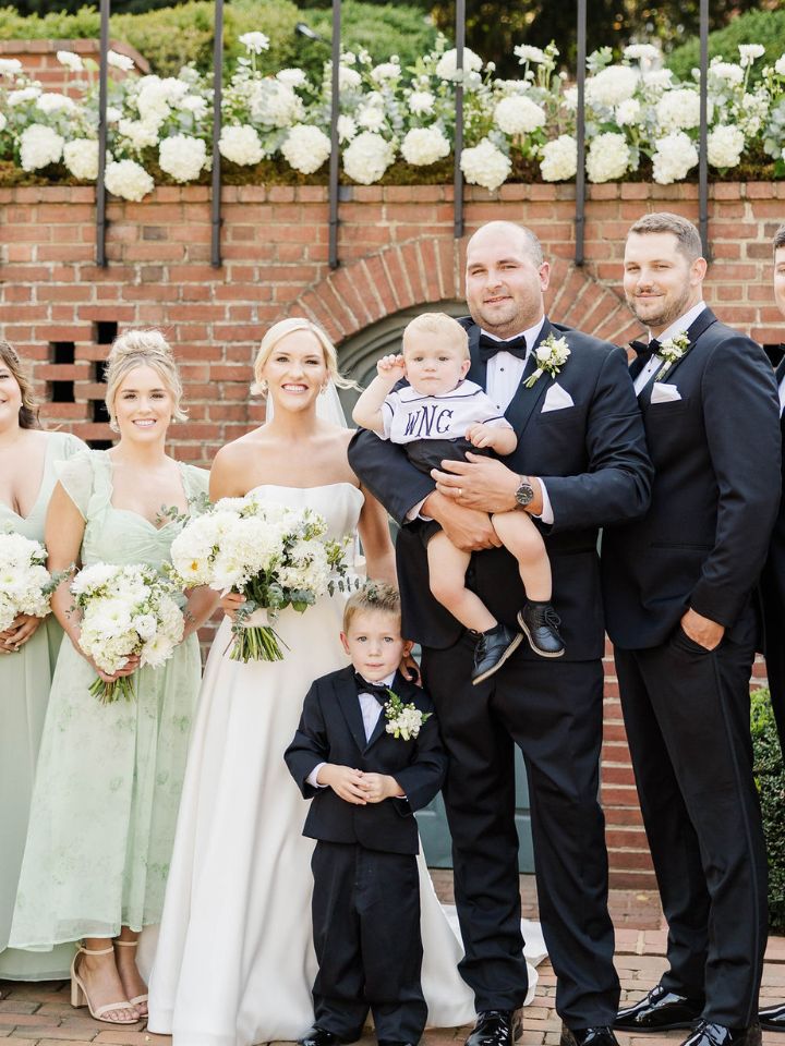 Wedding party poses with small kids.
