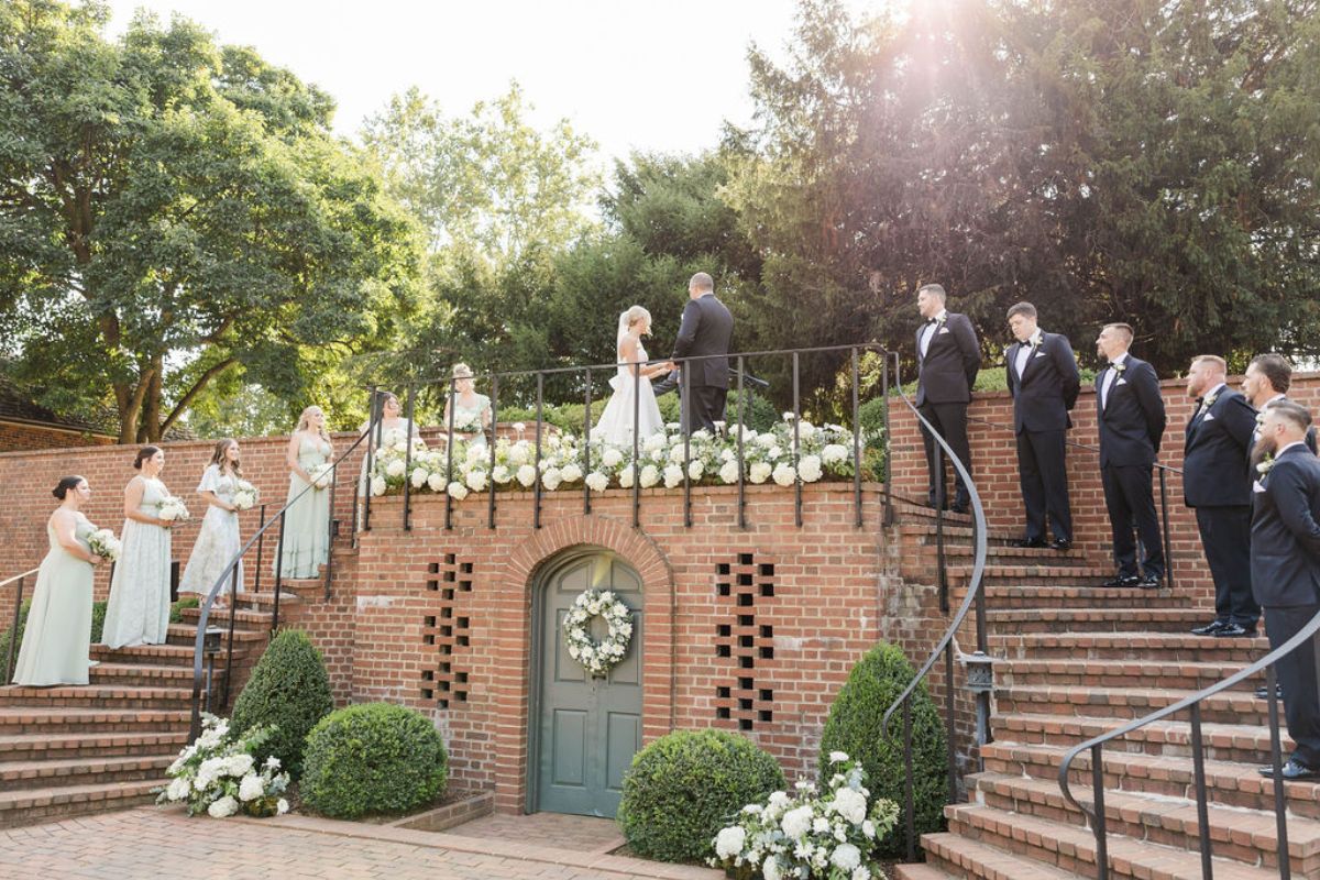 Wedding party on the curved brick staircase during wedding ceremony at Mount Harmon Plantation.