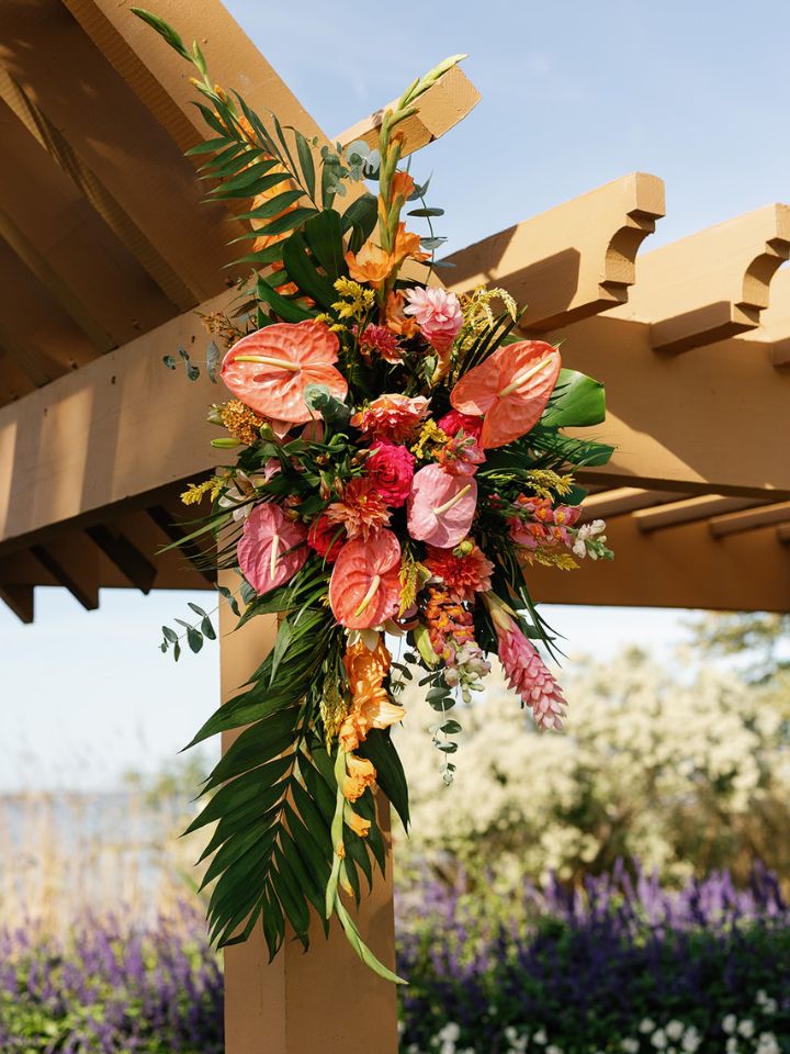 Detail of flower arrangement on wedding ceremony arch.