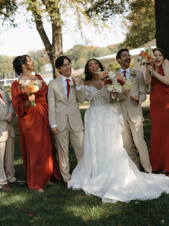 Bride and groom pose with wedding party.