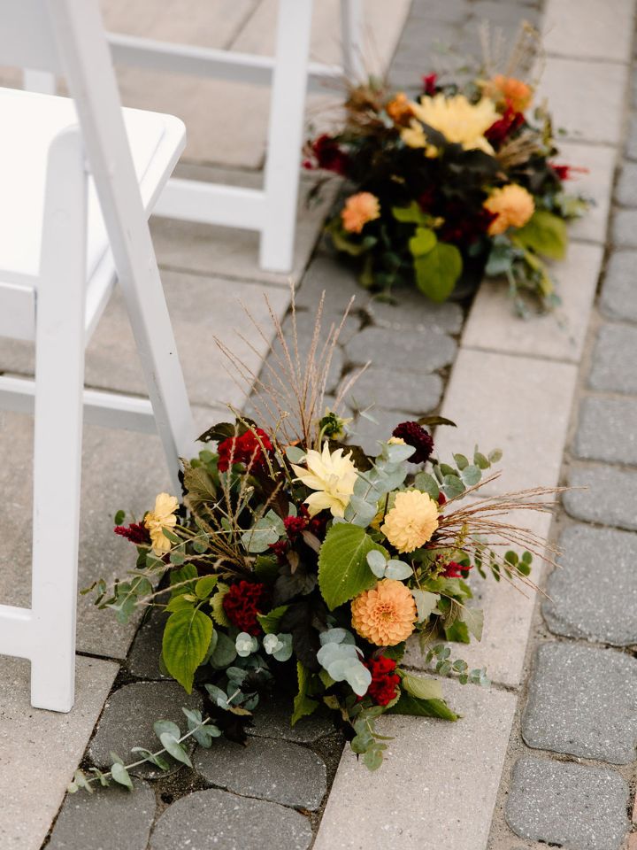 Aisle arrangements down the aisle at each chair.