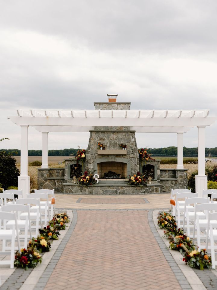 View down the wedding ceremony aisle with flowers at each chair.
