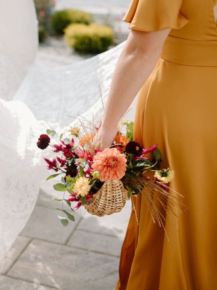Bridesmaid bouquet basket with fall flowers.