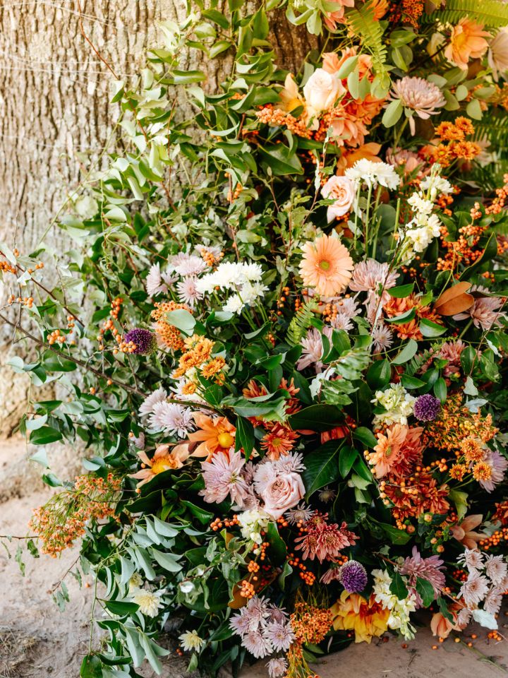 Closeup of flower arrangement on tree for wedding ceremony.