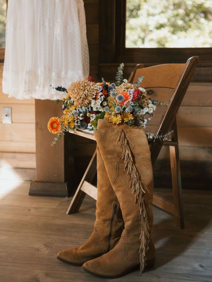 Suede fringe boots with dried flowers wedding bouquet.