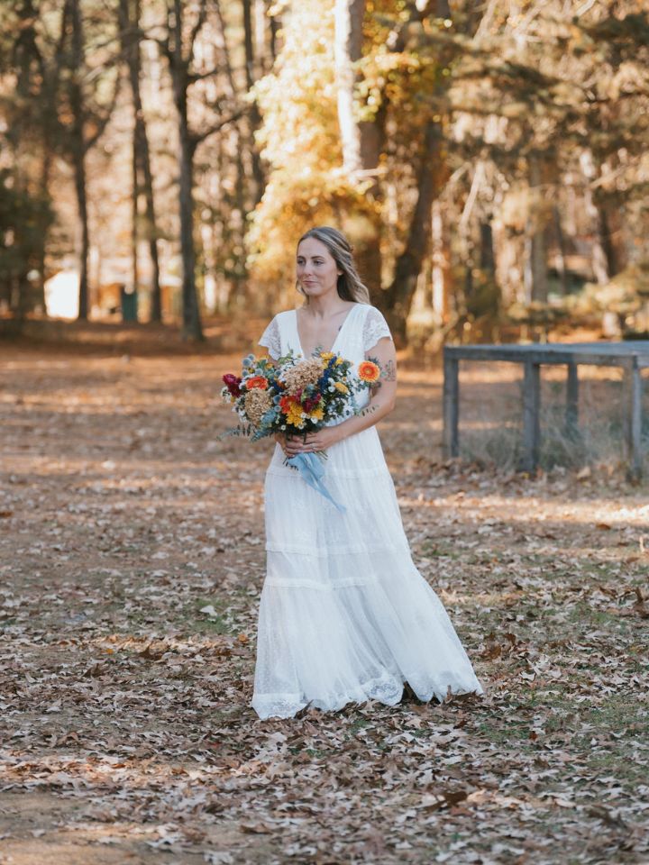 Bride walks down aisle towards ceremony.
