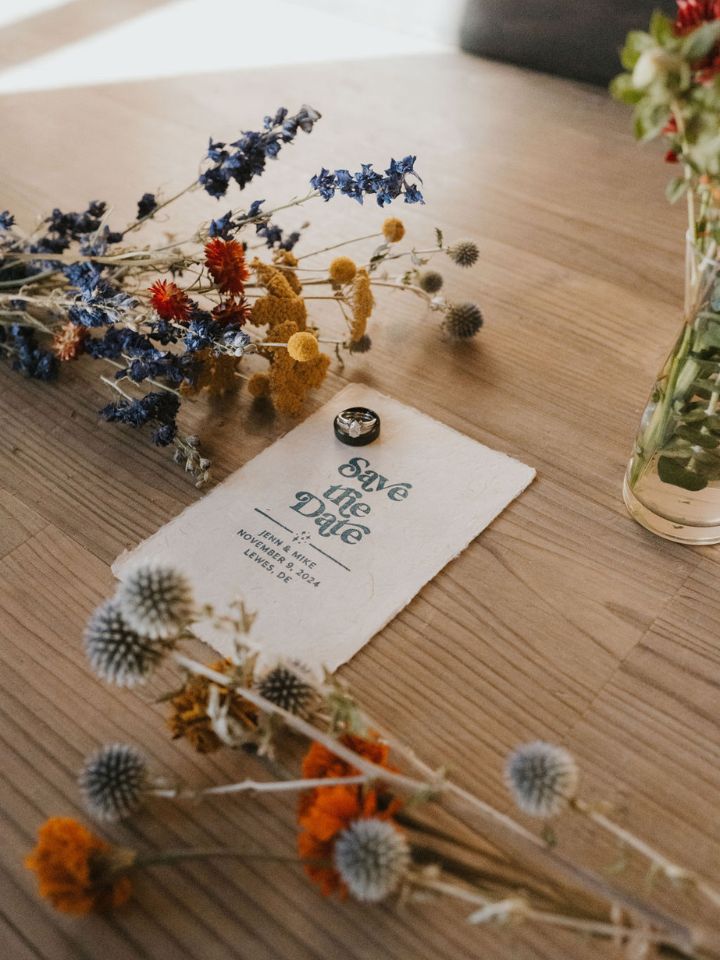 Wedding save the date with retro font and dried flowers.