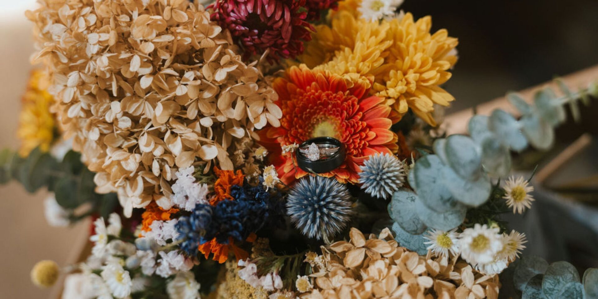 Closeup photo fo dried and fresh flowers in fall harvest hues.