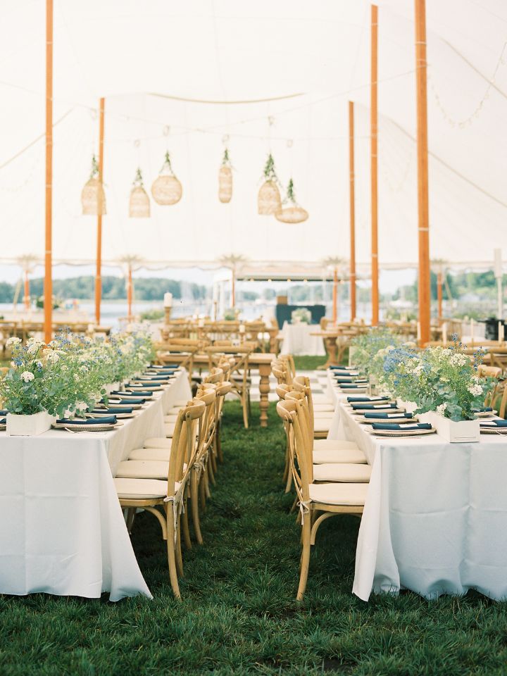 View between long reception tables at wedding.