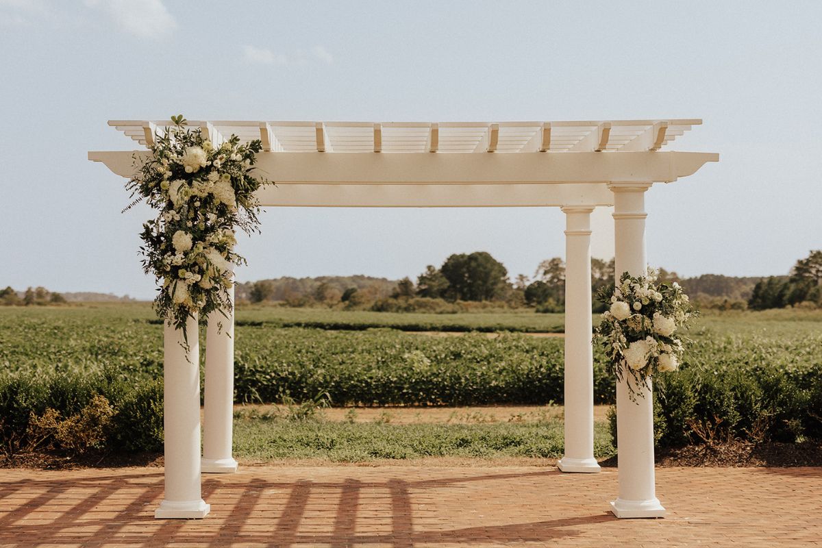 Large white pergola for wedding ceremony at Kent Island Resort.