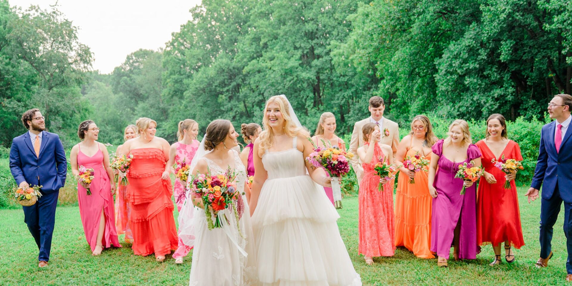 Brides walk with their bridal party at Woodend Sanctuary.