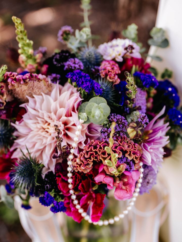 Detail of bridal bouquet with pearl necklace.