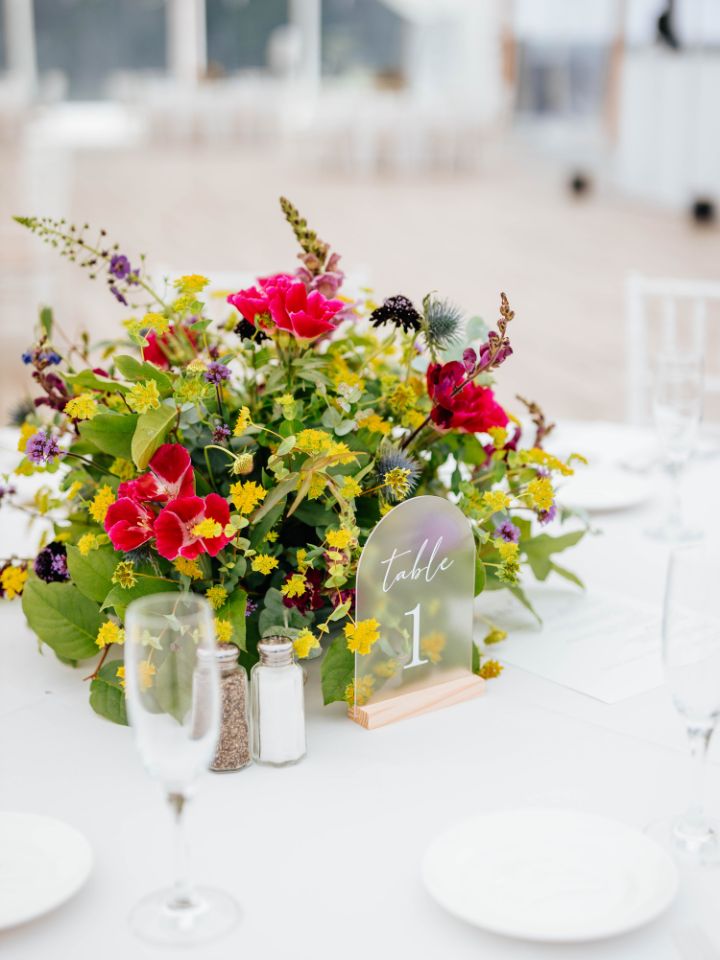 Bright colorful flower arrangement at a summer wedding.
