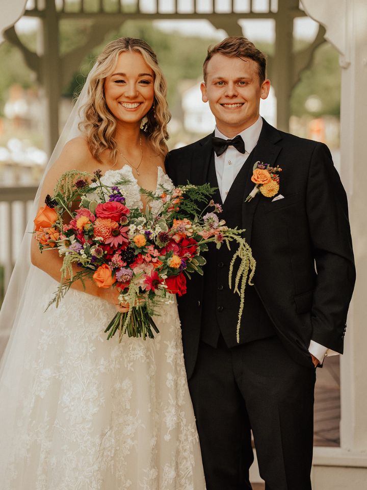 Bride and groom pose for photo.