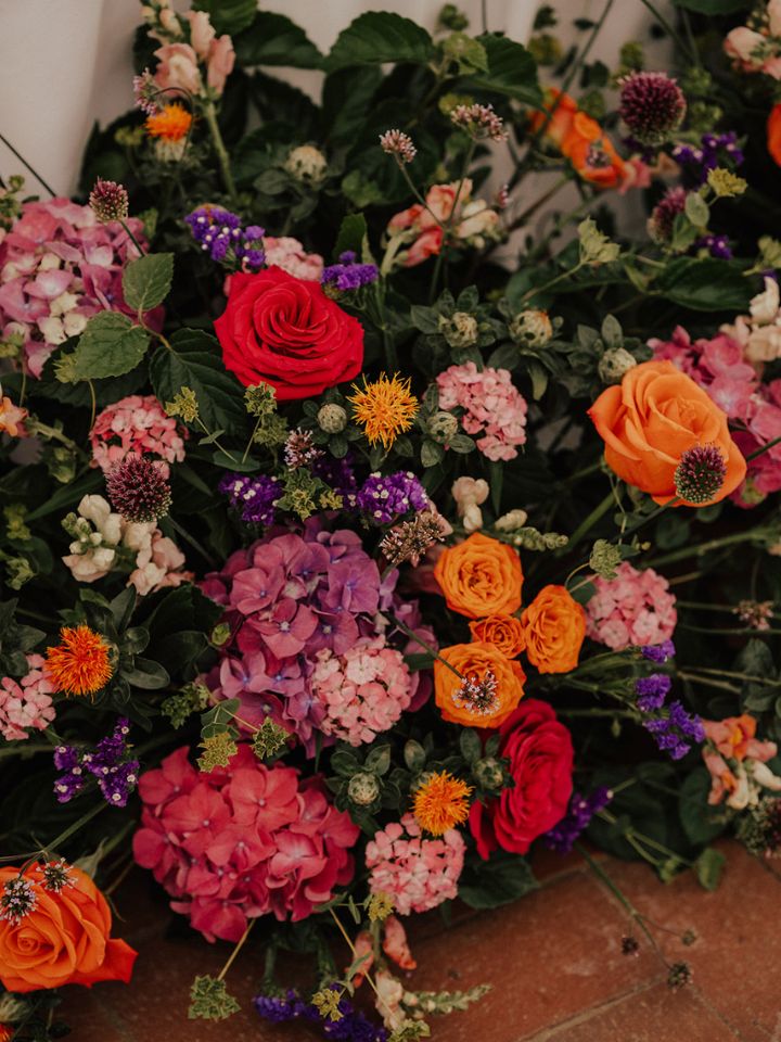 Detail of flower arrangements for summer garden wedding flowers in bright colors.
