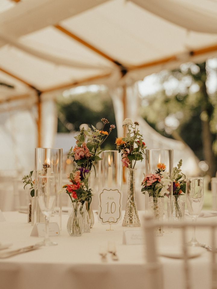 Guest table with flower bud vases.