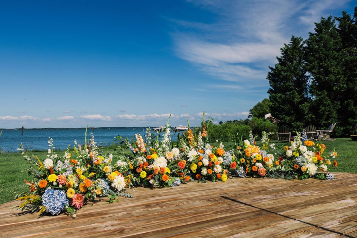Semi circle of flower arrangements for a wedding ceremony at a Wylder Hotel Summer Wedding.