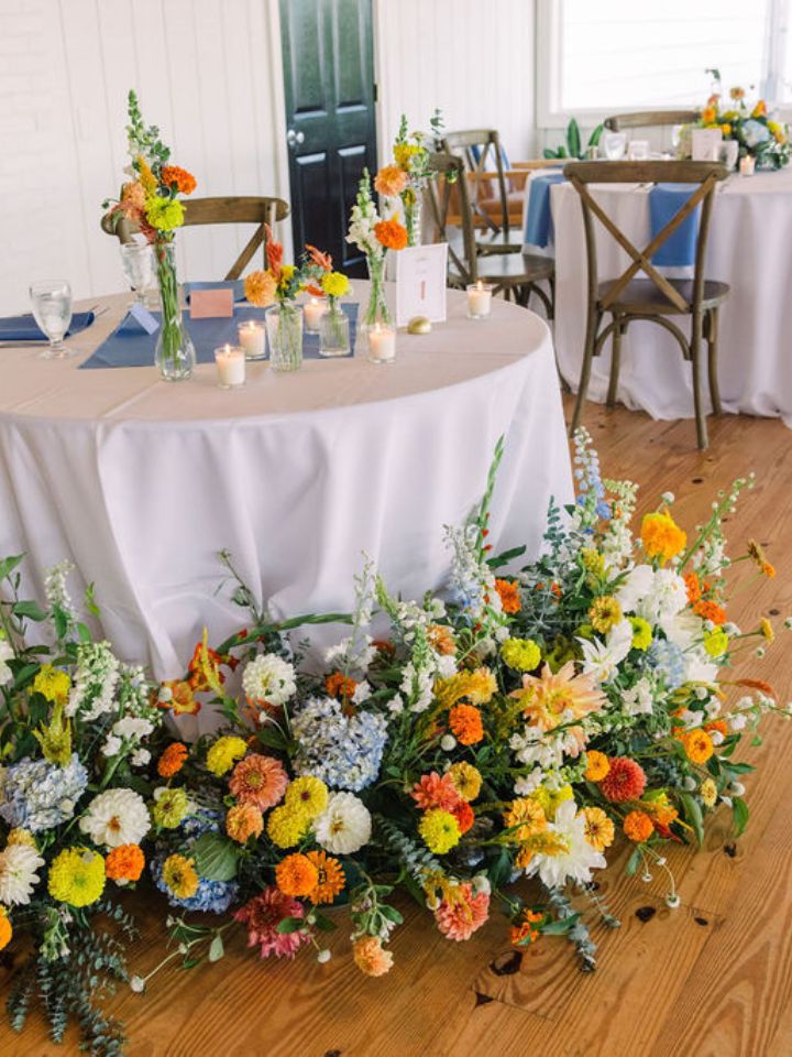 Sweetheart table with large flower arrangements at base during a Wylder Hotel summer wedding.