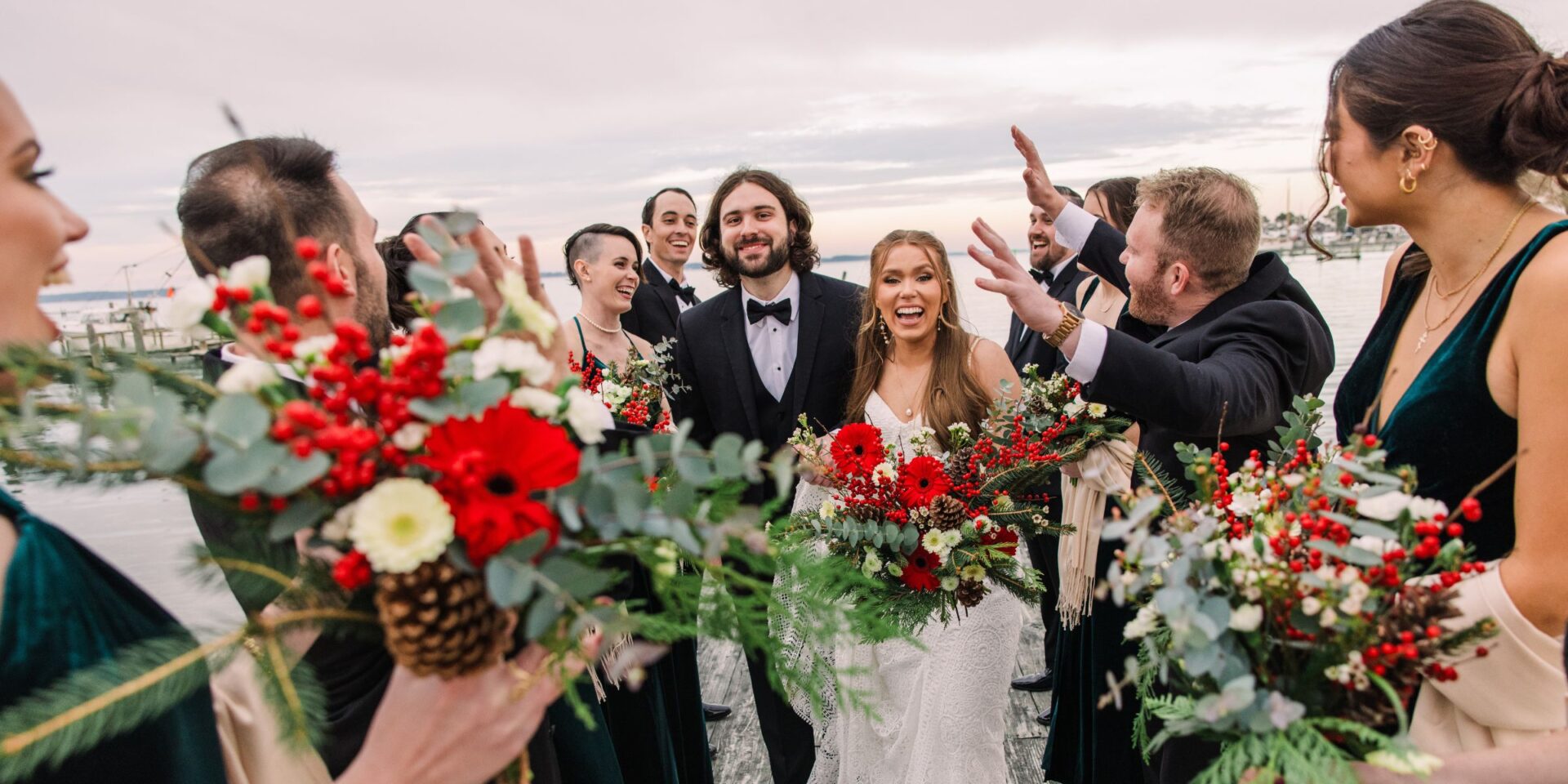 Bride and groom with Christmas wedding flowers and wedding party.