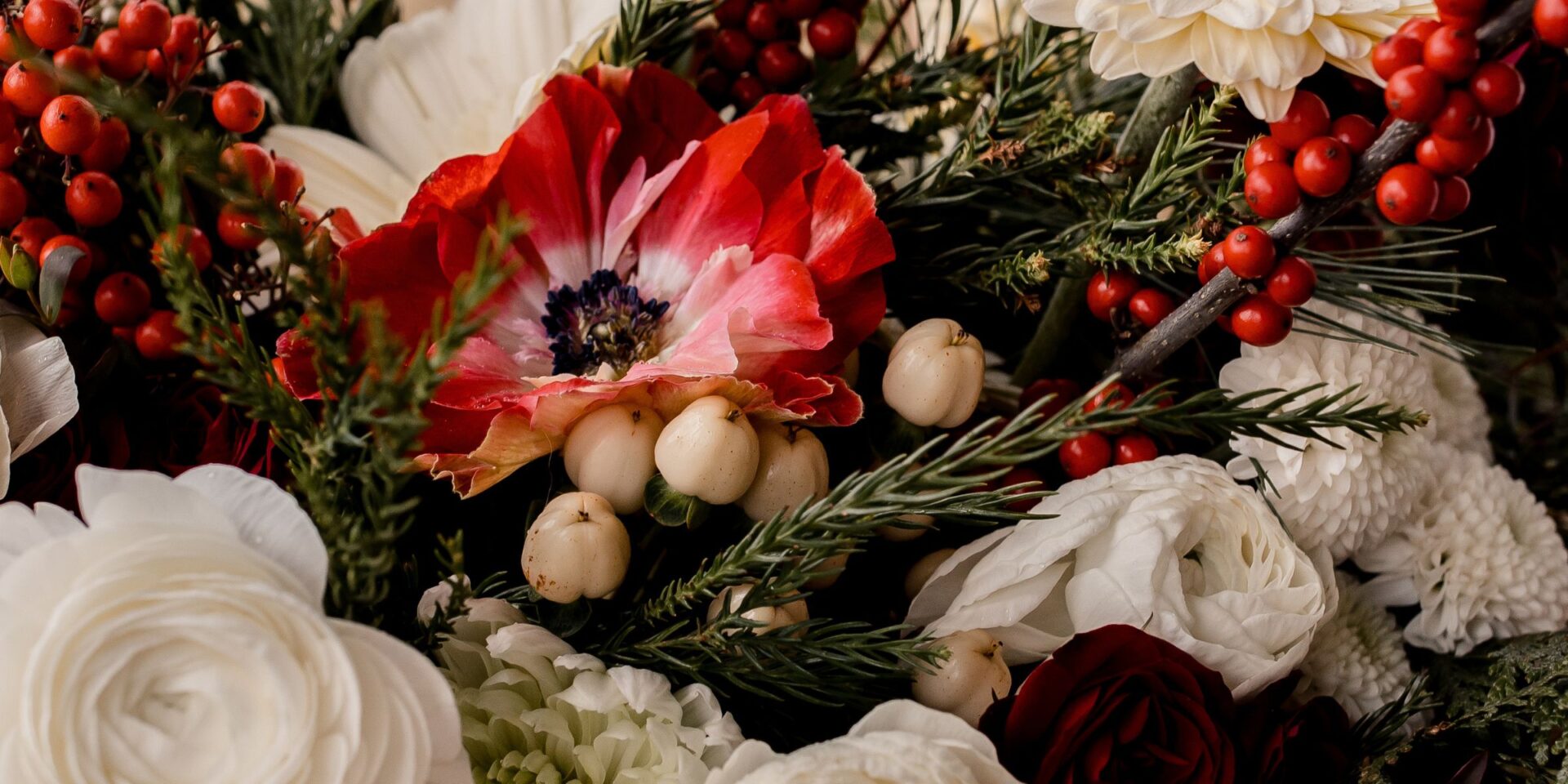 Closeup of red, white, and green flowers for a Christmas wedding.