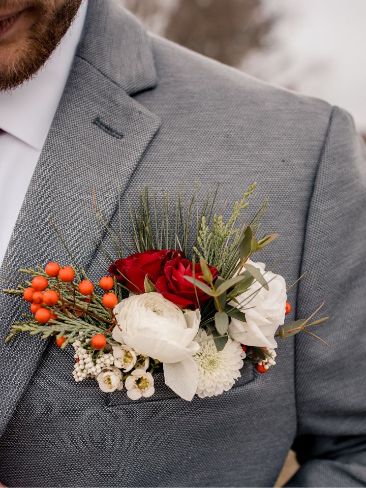 Grey suit with Christmas flowers pocket square.