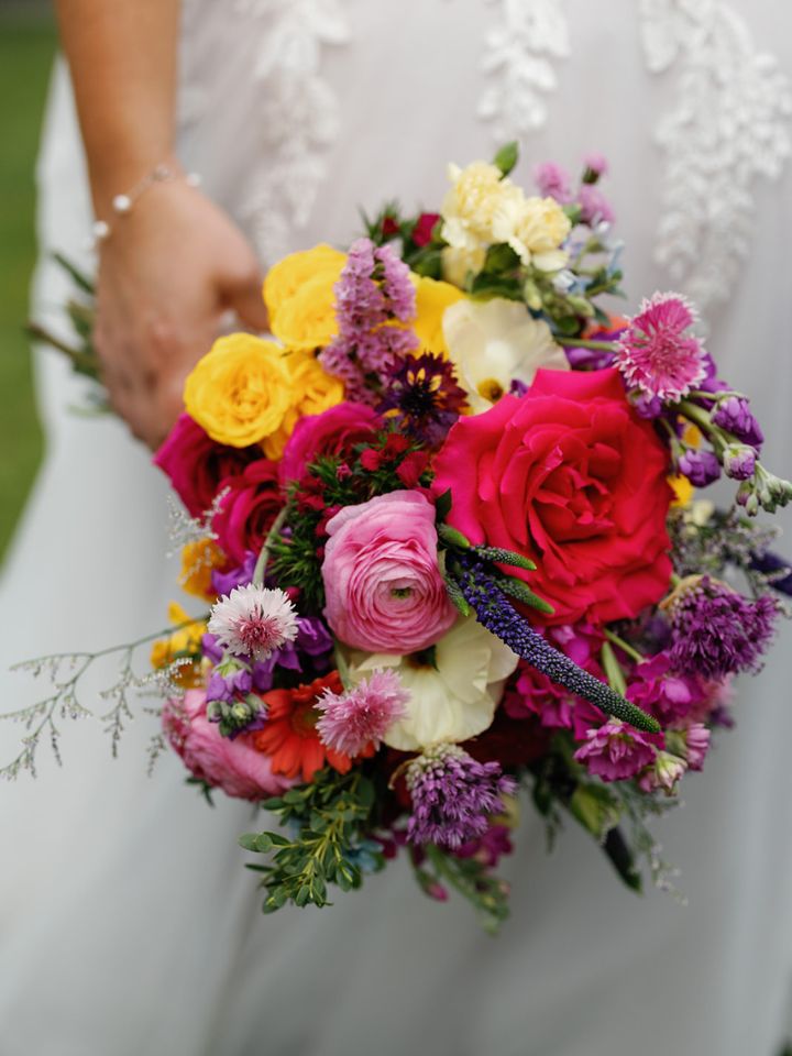 Bright spring wedding flowers in bridal bouquet.