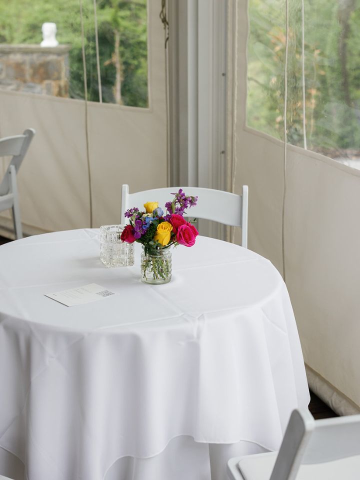 Cocktail table with small flower vase arrangement.