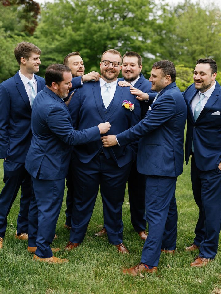 Groom and groomsmen in dark blue navy suits.