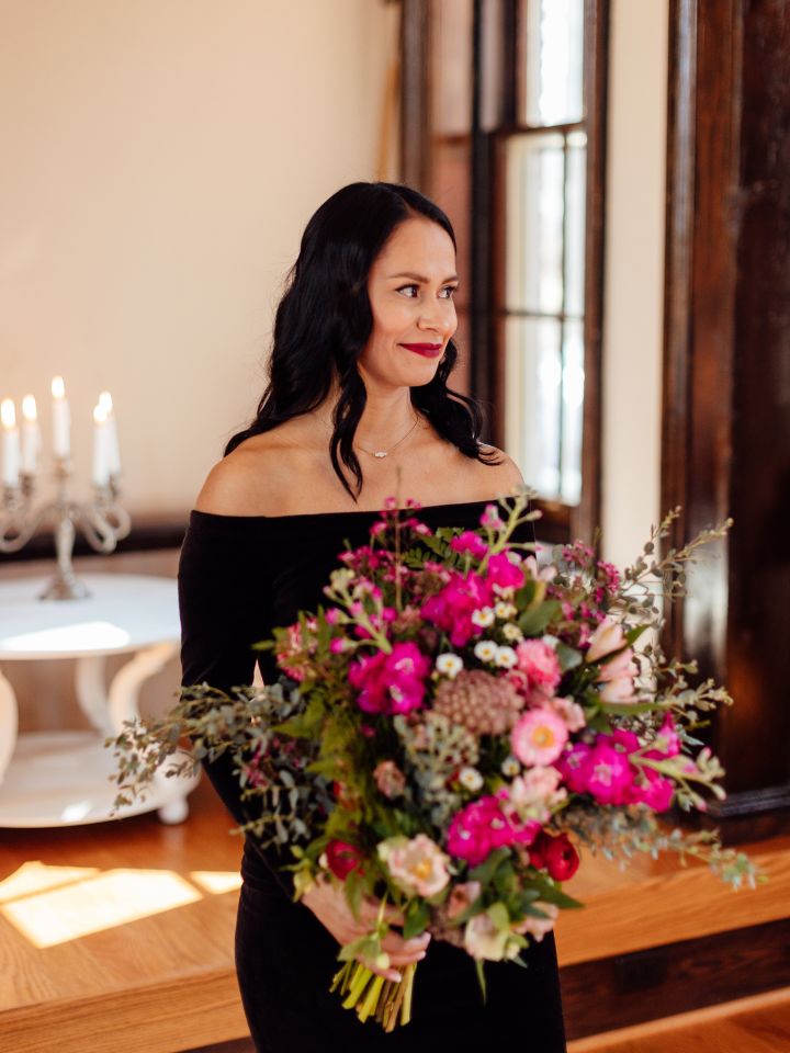 Bride holds her bouquet inside chapel.