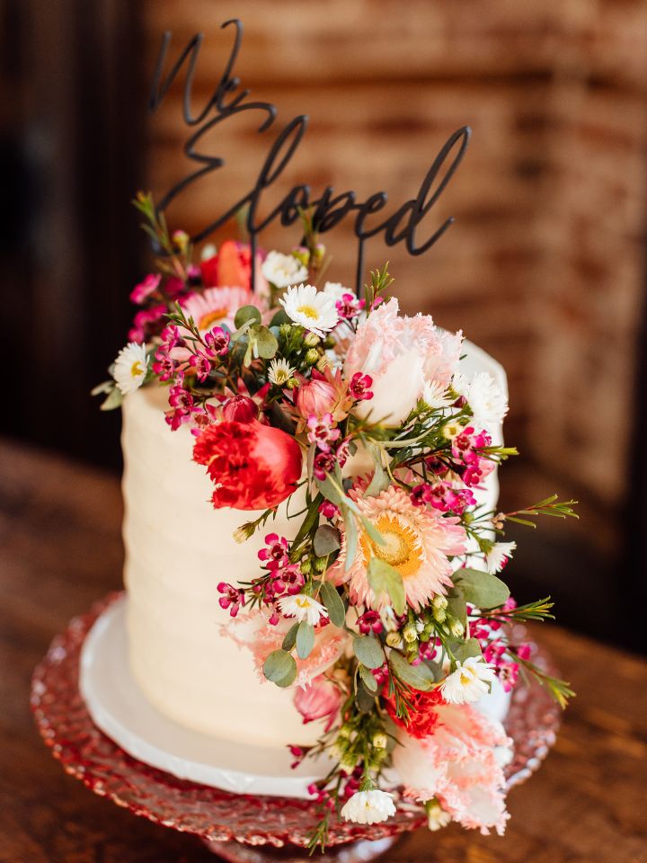 Wedding cake with colorful winter flowers.