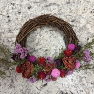 Make a dried flower wreath with pink and purple dried flowers.