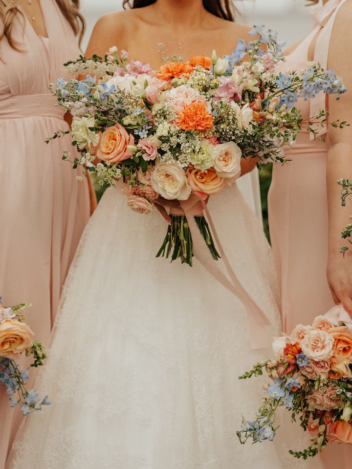 Bride and bridesmaids holding bouquets.